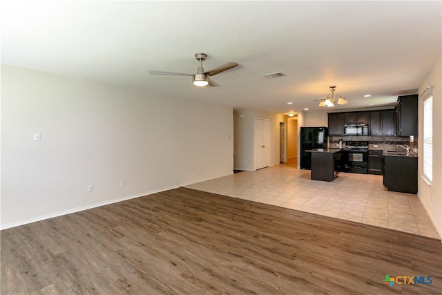 1321 Cozy Creek Dr, Temple, TX 76502 - unfurnished living room featuring light wood-style flooring, a chandelier, a ceiling fan, and recessed lighting