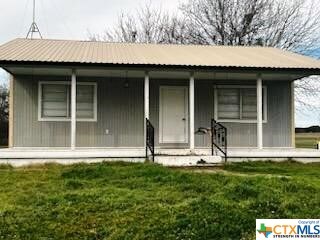 301 Fm 1467 S, Unit S, TX 76890 - view of front of house with covered porch and a front lawn