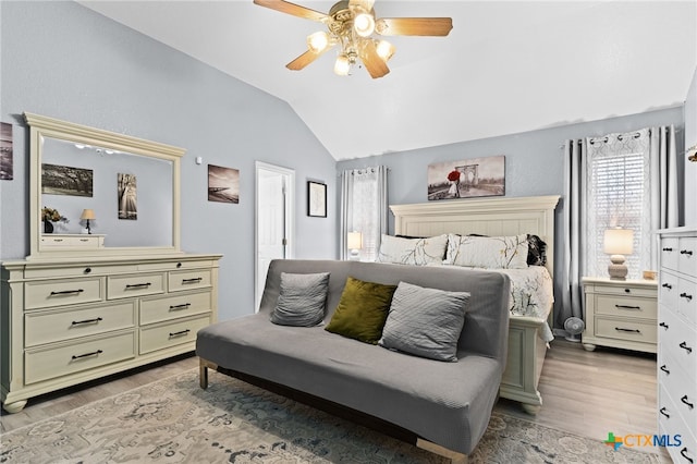 bedroom featuring light wood-style flooring, a ceiling fan, and lofted ceiling
