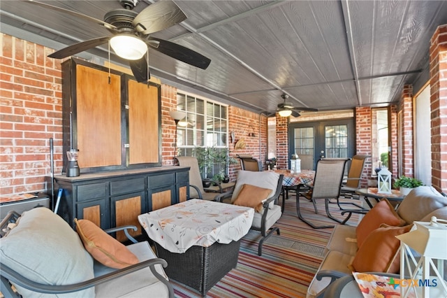 interior space with outdoor dining space, french doors, and a ceiling fan