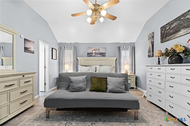 bedroom featuring light wood-style flooring, a ceiling fan, baseboards, and lofted ceiling