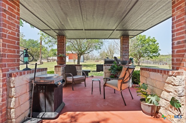 view of patio / terrace featuring fence