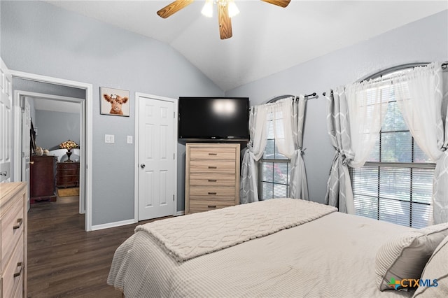 bedroom featuring dark wood-type flooring, baseboards, ceiling fan, and vaulted ceiling