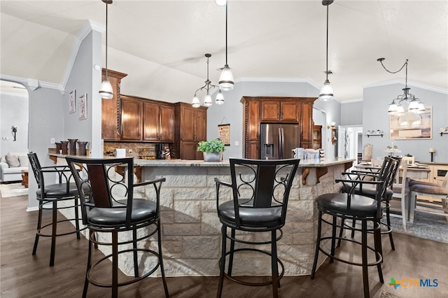 kitchen with dark wood-style flooring, backsplash, stainless steel refrigerator with ice dispenser, and a notable chandelier
