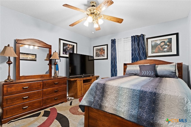bedroom featuring ceiling fan and carpet