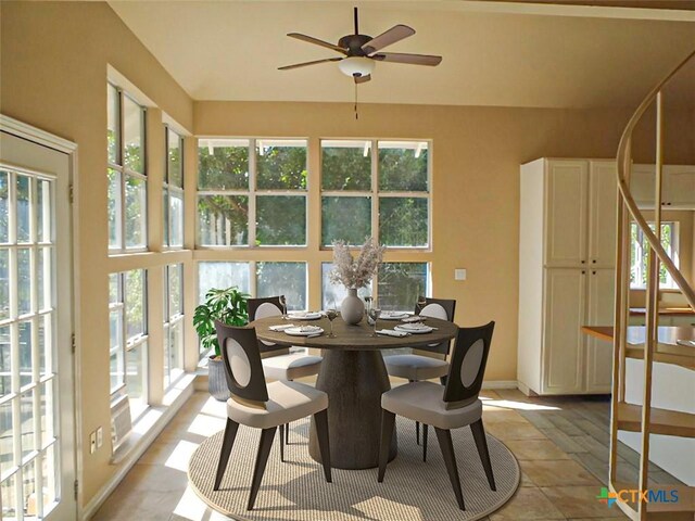 tiled dining space featuring ceiling fan and plenty of natural light