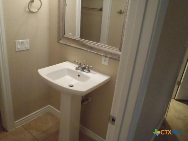 bathroom with tile patterned floors and sink