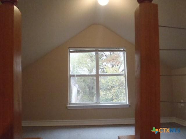 additional living space featuring vaulted ceiling