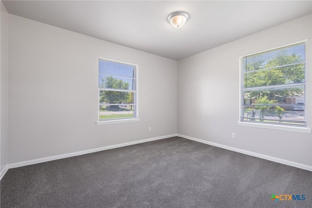 716 S 3rd St, Copperas Cove, TX 76522 - spare room featuring dark colored carpet and baseboards