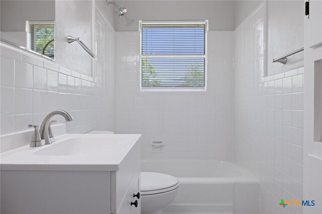 716 S 3rd St, Copperas Cove, TX 76522 - full bathroom featuring vanity, plenty of natural light, bathing tub / shower combination, and tile walls