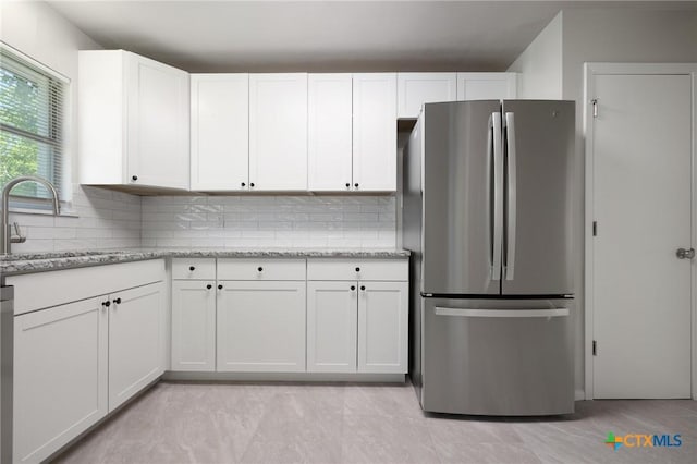 716 S 3rd St, Copperas Cove, TX 76522 - kitchen featuring freestanding refrigerator, white cabinets, and tasteful backsplash