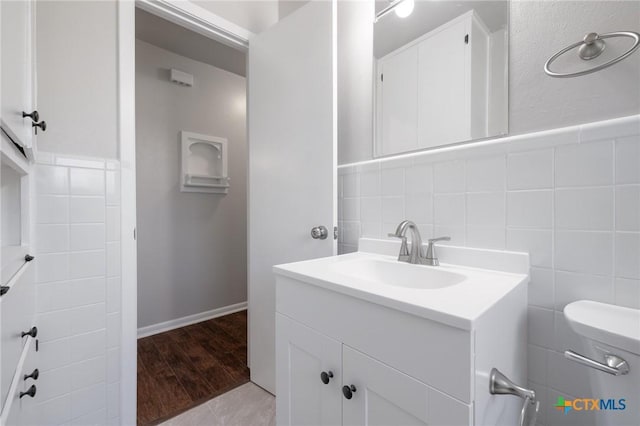 716 S 3rd St, Copperas Cove, TX 76522 - bathroom featuring vanity, tile walls, and wood finished floors