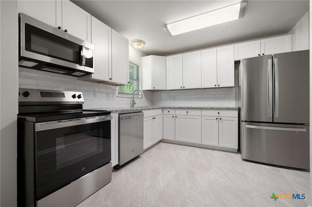 716 S 3rd St, Copperas Cove, TX 76522 - kitchen with appliances with stainless steel finishes, backsplash, white cabinetry, and light stone countertops