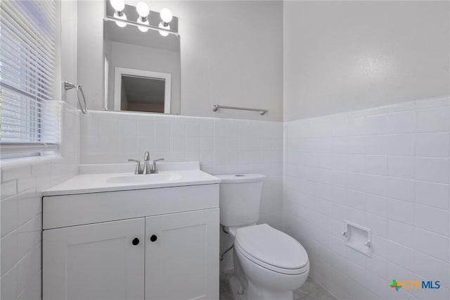 716 S 3rd St, Copperas Cove, TX 76522 - half bath with tile walls, vanity, and a wainscoted wall
