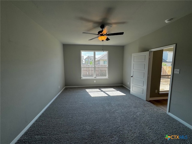 unfurnished bedroom featuring dark carpet and ceiling fan