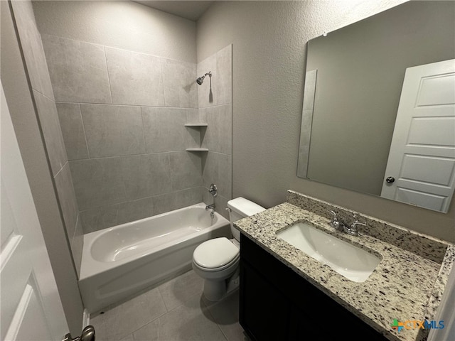 full bathroom featuring vanity, tile patterned flooring, tiled shower / bath, and toilet