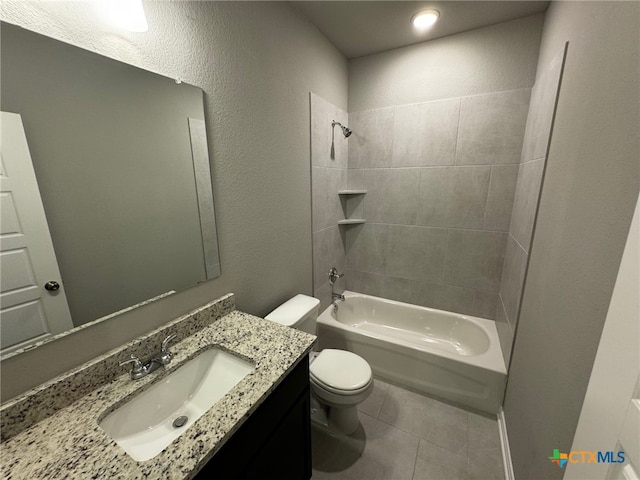 full bathroom featuring tile patterned flooring, vanity, tiled shower / bath combo, and toilet