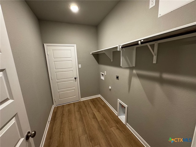 clothes washing area featuring gas dryer hookup, washer hookup, dark hardwood / wood-style floors, and hookup for an electric dryer