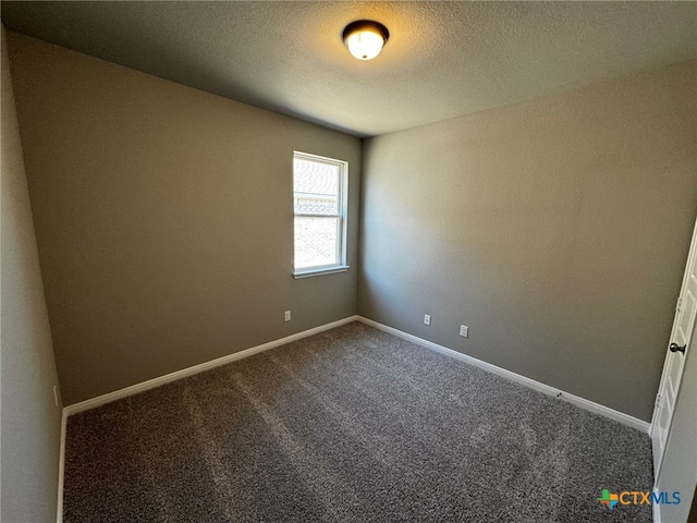 carpeted spare room with a textured ceiling