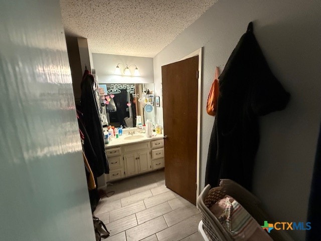 410 Phoenix Dr, Temple, TX 76504 - bathroom featuring a textured ceiling and vanity