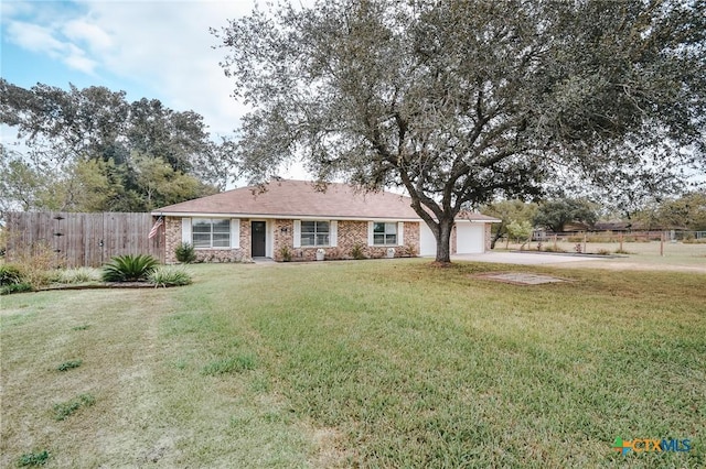 single story home with an attached garage, fence, concrete driveway, and a front yard