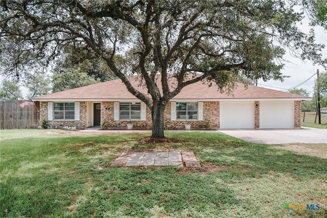 ranch-style house featuring brick siding, concrete driveway, an attached garage, fence, and a front lawn