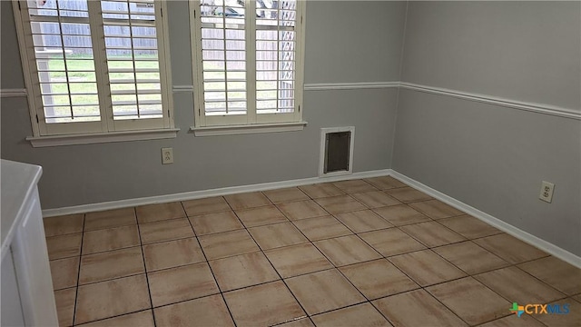 unfurnished room with baseboards