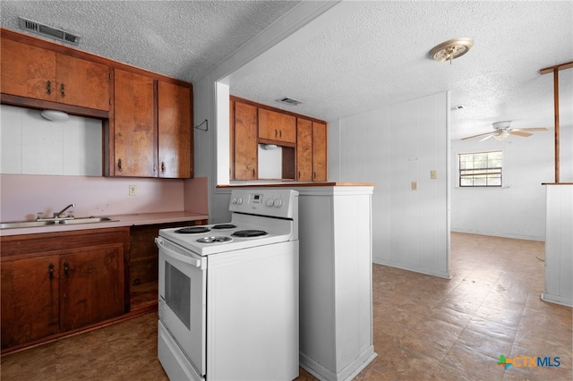 1202 S 3rd St, Copperas Cove, TX 76522 - kitchen featuring white range with electric cooktop, brown cabinetry, ceiling fan, a textured ceiling, and light countertops