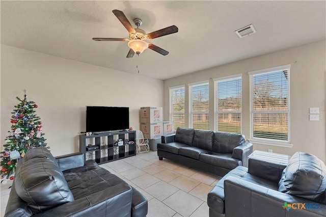 tiled living room with ceiling fan