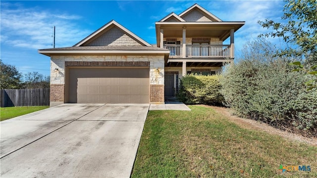 view of front of house featuring a balcony and a front lawn