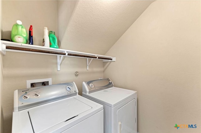 clothes washing area featuring washing machine and clothes dryer