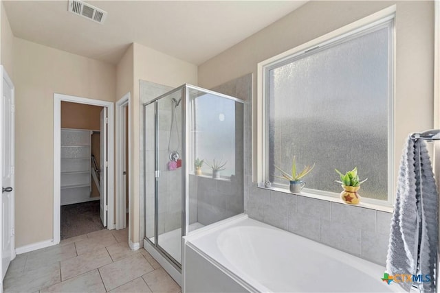 bathroom featuring tile patterned floors and plus walk in shower