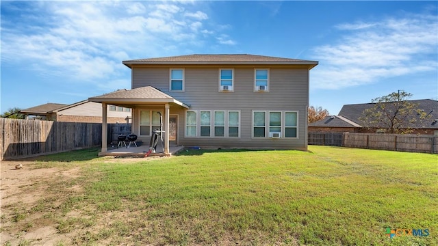 rear view of property with a yard and a patio area