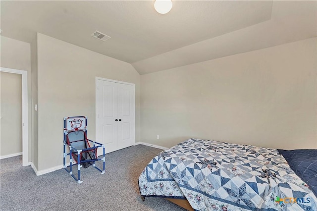 bedroom featuring carpet, lofted ceiling, and a closet