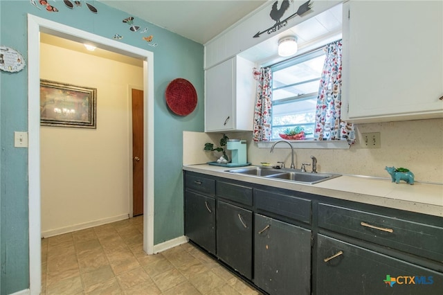 1105 E Robertson Ave, Copperas Cove, TX 76522 - kitchen featuring light countertops, white cabinets, and dark cabinetry