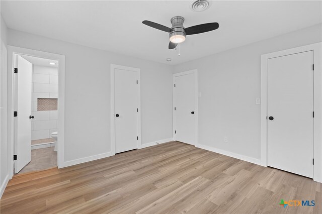 711 Santa Rosa Dr, Killeen, TX 76541 - unfurnished bedroom with light wood finished floors, ensuite bath, and a ceiling fan