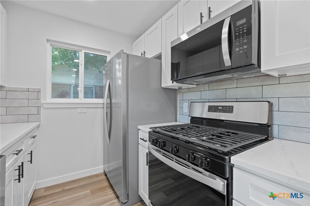 711 Santa Rosa Dr, Killeen, TX 76541 - kitchen featuring stainless steel appliances, white cabinetry, light wood finished floors, and backsplash