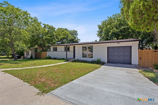 711 Santa Rosa Dr, Killeen, TX 76541 - view of front of home featuring an attached garage, driveway, and brick siding