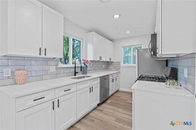 711 Santa Rosa Dr, Killeen, TX 76541 - kitchen with stainless steel appliances, light countertops, light wood-style flooring, white cabinetry, and recessed lighting