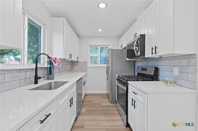 711 Santa Rosa Dr, Killeen, TX 76541 - kitchen featuring stainless steel appliances, white cabinetry, tasteful backsplash, recessed lighting, and light wood-style floors