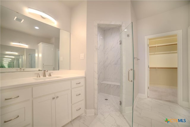 bathroom featuring vanity, visible vents, a marble finish shower, baseboards, and marble finish floor