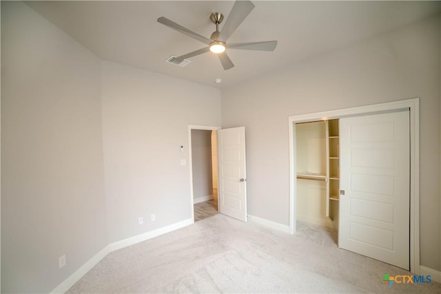 unfurnished bedroom with visible vents, a ceiling fan, a closet, carpet floors, and baseboards