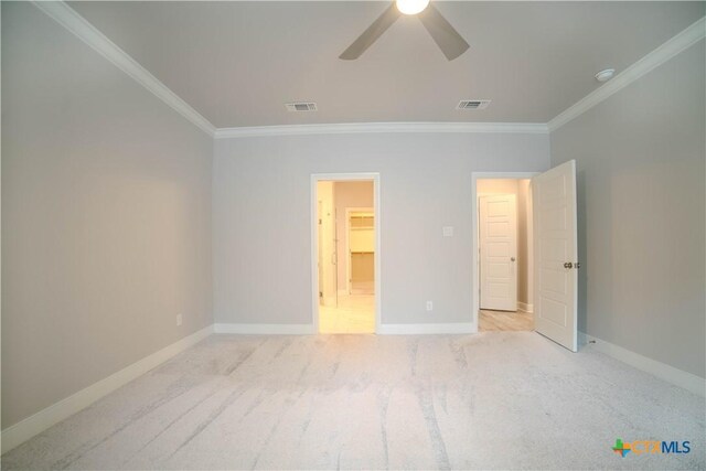 unfurnished bedroom with visible vents, carpet, and ornamental molding