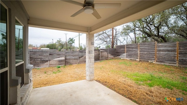 view of yard featuring a fenced backyard, ceiling fan, and a patio area