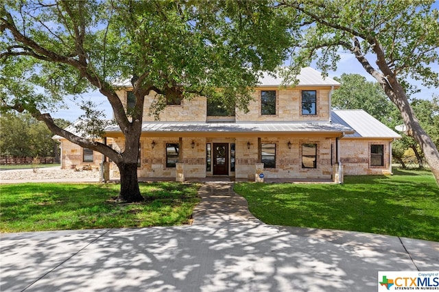 view of front of home with a porch and a front lawn