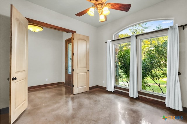 interior space featuring multiple windows and ceiling fan