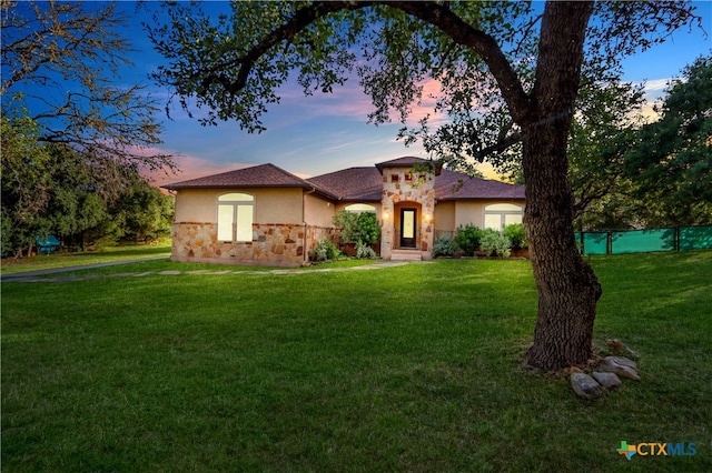 mediterranean / spanish home with a yard