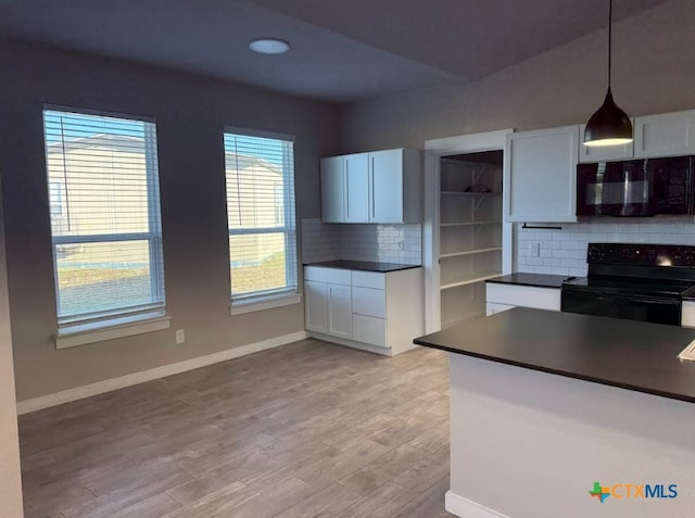 kitchen featuring decorative backsplash, black appliances, light hardwood / wood-style floors, white cabinetry, and hanging light fixtures