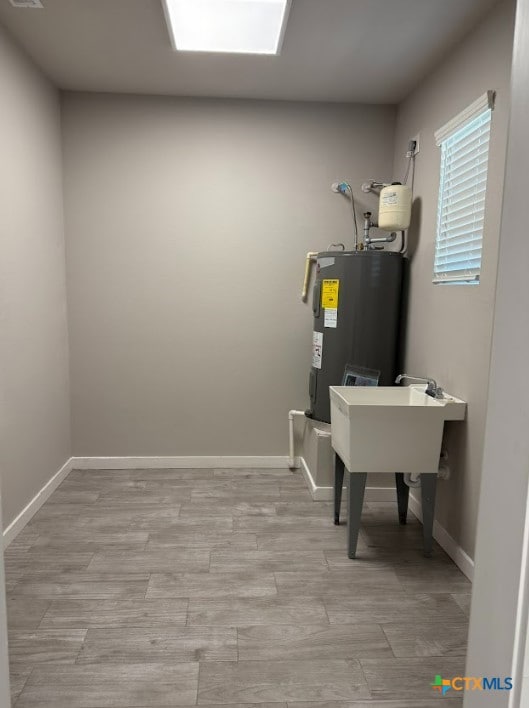 utility room featuring water heater