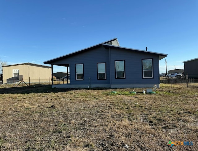 rear view of property featuring a lawn